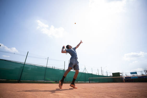 istock young man playing tennis 1444455373