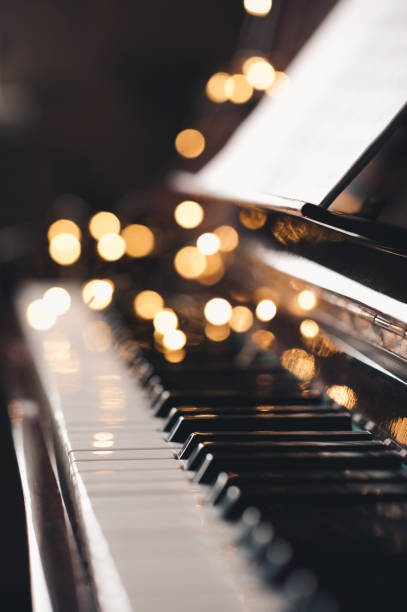 piano keys with glow lights - piano piano key orchestra close up imagens e fotografias de stock