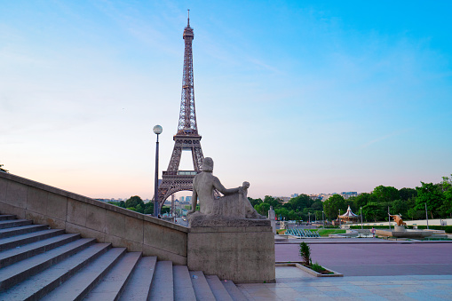 Paris Eiffel Tower and Trocadero garden at sunset in Paris, France. Eiffel Tower is one of the most famous landmarks of Paris.