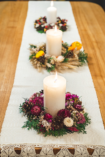 Set of three beautiful hand crafted Christmas wreaths with candles.