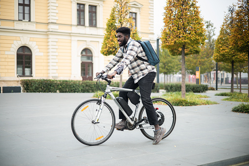 Man with an electric bicycle traveling to work