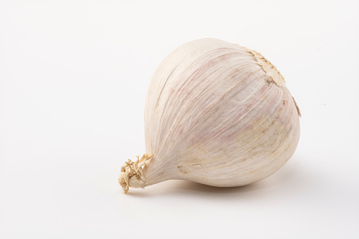head of garlic and herbs on a wooden table close-up. healthy food. rustic style. selective focus