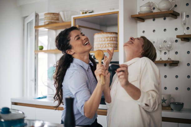 Mother and daughter enjoying in the kitchen. stock photo