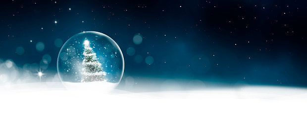 Snow globe with snowflakes and Christmas tree in snow