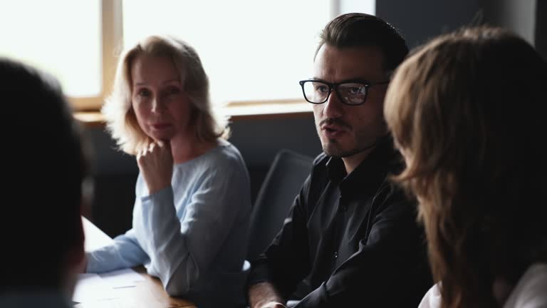 Negotiations of diverse business people in board room