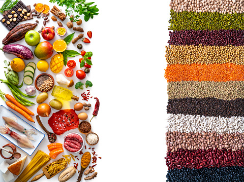 Food and drink large arrangement with carbohydrates protein vegetables and fruits legumes and dairy products on white background leaving side copy space