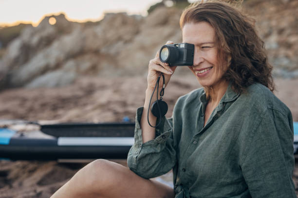 istock Woman taking pictures on the beach 1444482821