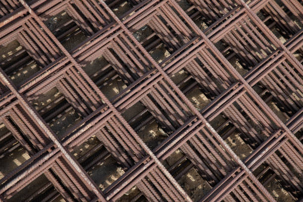 Pleasing symmetrical pattern formed by concrete reinforcement steel metal meshes, iron rods used for increased strength in cast concrete applications in construction, transportation or building sector.