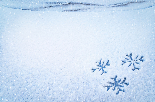 Frosty patterns on the edge of a frozen window.