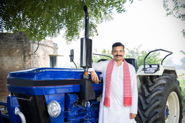 portrait of indian rural farmer with tractor. - farmers cheese imagens e fotografias de stock