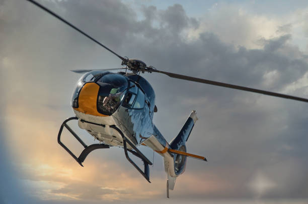 istock helicopter flying in sky at sunrise 1444491873