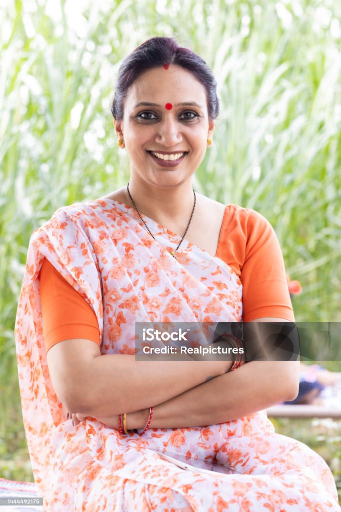 Portrait of indian woman in sari at village. Portrait of  indian woman in sari. One Woman Only Stock Photo