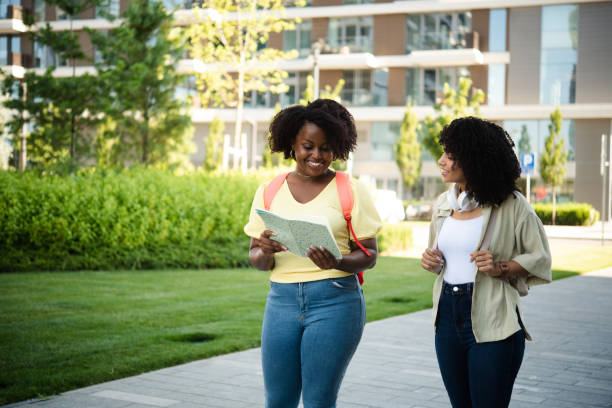 istock Two happy female students going to university and discussing their lesson 1444495019