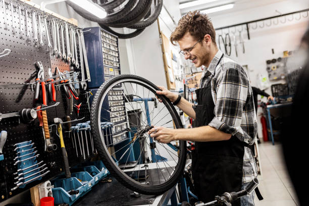 istock Bicycle mechanic repairing a customer bicycle wheel 1444495090