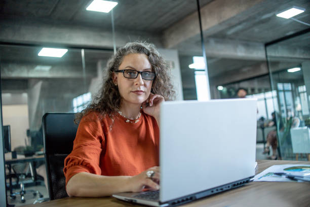 istock Mature woman working in office 1444496440