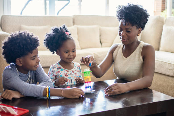 istock Mother playing table games with kids at home 1444496482