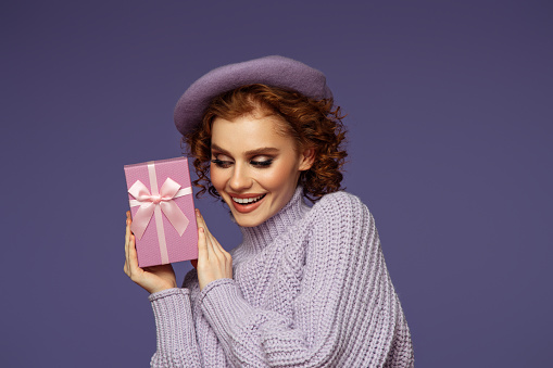 Beautiful emotional woman holding a gift