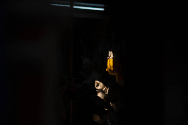 Creepy silhouette in the dark abandoned building. Horror about maniac concept or Dark corridor with cabinet doors and lights with silhouette of spooky horror person standing with different poses.