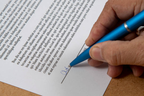 istock printed document signature showing a hand and ballpoint pen 1444499976