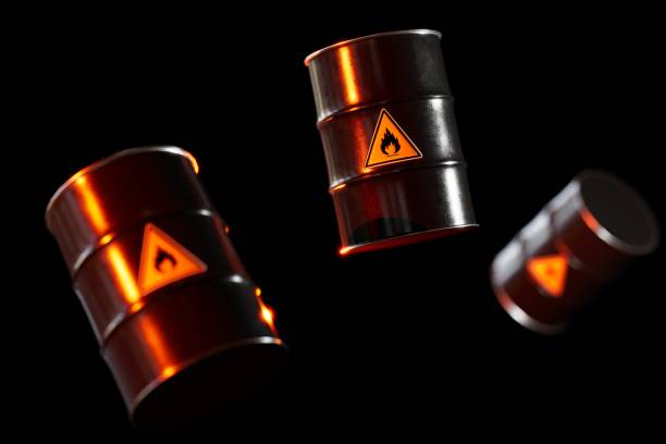 istock barrels of oil illuminated with red light, flying on a black background. 3D render 1444500302