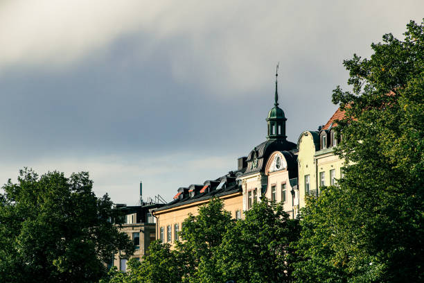 Low angle view of trees and buildings against sky
