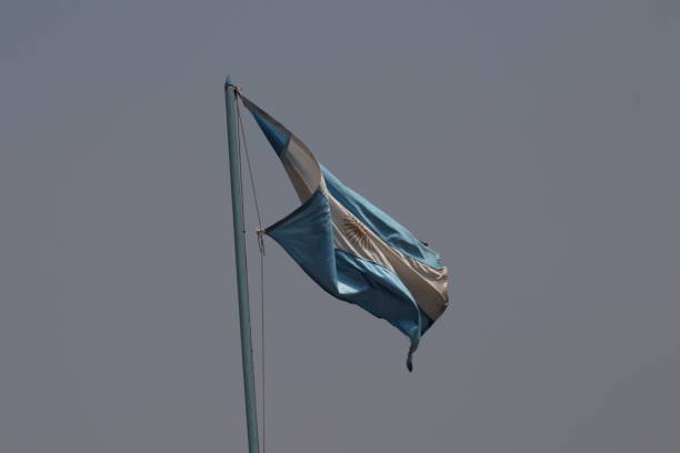istock Argentinian flag waving against grey sky 1444501603