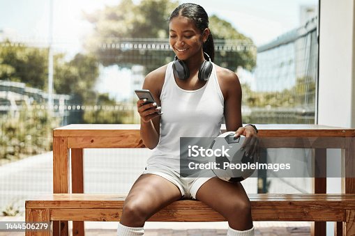 istock Soccer, phone and black woman football athlete with a ball on sports rest after exercise and fitness. Training workout and game break of a healthy person smile using mobile technology and 5g internet 1444506279