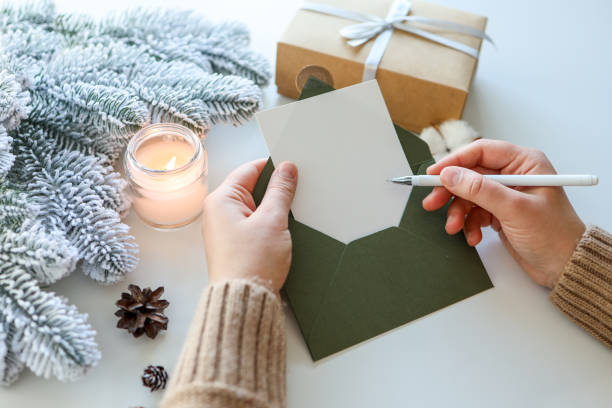istock Girl with a greeting card in her hands writes a congratulation 1444506752