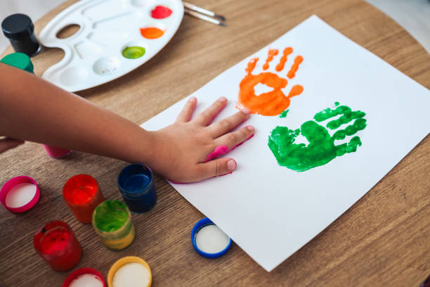 istock Children's master class in drawing, the child makes a handprint with paint 1444507602