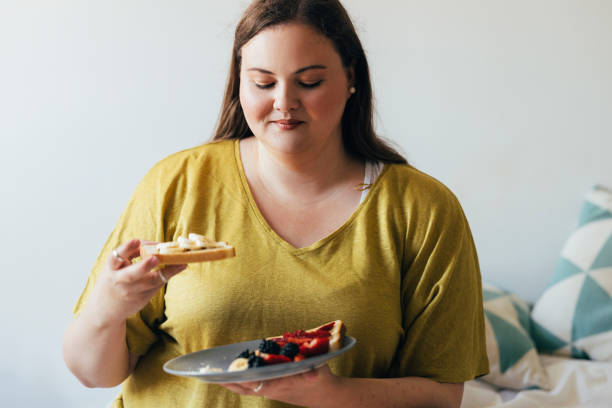 istock Overweight Woman Eating Her Breakfast 1444508089