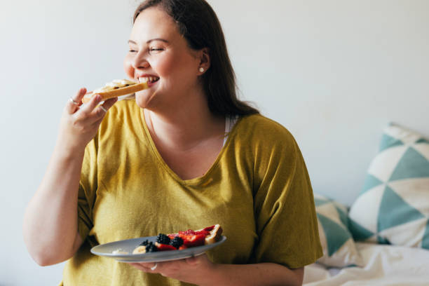 istock Overweight Woman Enjoying Her Breakfast 1444508106