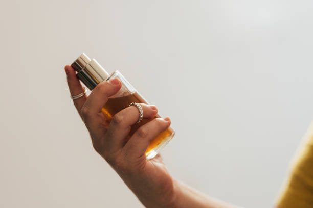 istock Anonymous Woman Holding A Bottle Of Perfume 1444508131