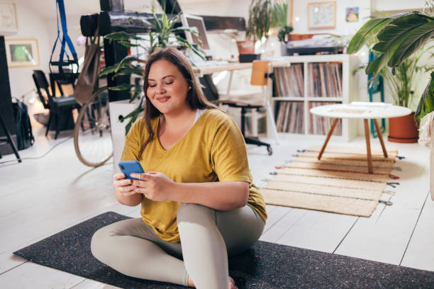 Overweight Woman Texting On Smartphone