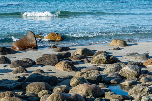 Large natural rocks on a sand beach, Norway, Brusand