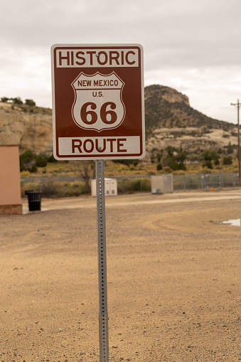 This shot shows a tween boy riding on a paved bike trail.  Taken on a winter day in southern Arizona.  A warning sign sits next to the trail.