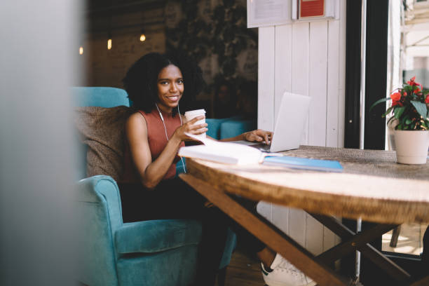 istock Smiling ethnic woman drinking coffee in cafe 1444516950