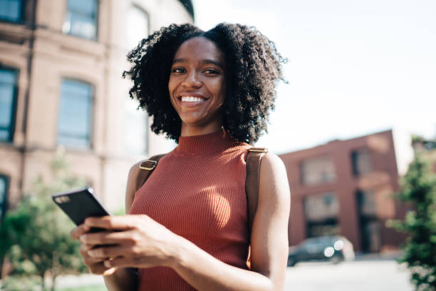 istock Content black lady texting on cellphone 1444517225