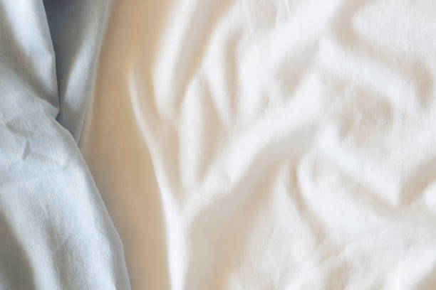 istock Abstract crumpled linen fabric texture background. Natural light blue hue dyed linen and white color blend linen fabric background. Top view 1444519150