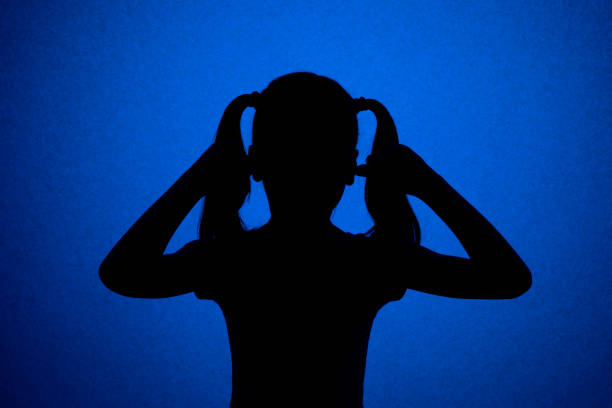 a high contrast image of a person in a hoodie shirt with an urban style. Saturated sunset of bordeaux, reds, and oranges