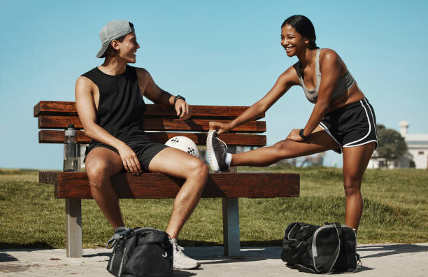 istock Exercise, stretching and sports couple relax in park, talking while getting ready for sport, training and wellness workout. Athletic, woman and man excited for recreation fun outdoors together 1444524070