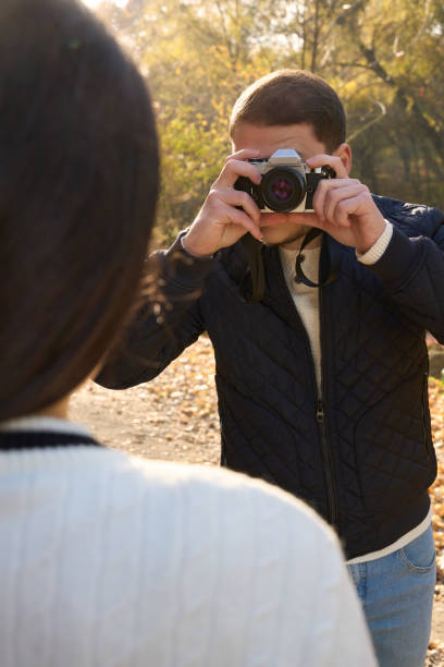 istock Guy in casual clothes holds a camera to his face 1444524596