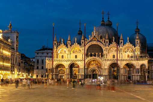 Venice, Italy - July 17, 2018: Night shot with people at the Basilica di San Marco (St. Mark's Cathedral), Venice, Italy