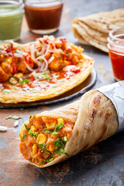 istock Aloo Corn or potato Corn paratha roll kathi shawarma wrap with dipping sauce isolated on background side view of indian fastfood 1444524844