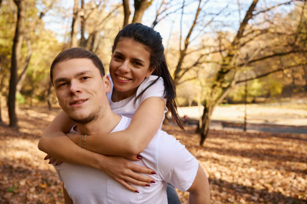 istock Athletic guy rides his joyful girlfriend on backs 1444525590