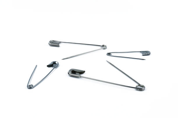 istock Open and scattered standing safety pins isolated on white background 1444529298
