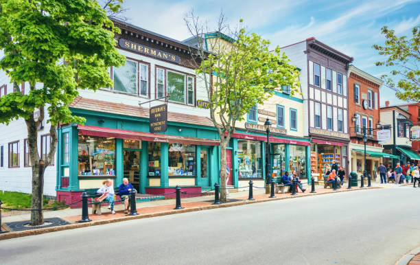Shopping Bar Harbor Bar Harbor, Maine, USA May 26, 2022- Passengers from a cruise ship anchored off shore spend their time exploring and shopping the stores and shops along Main Street in Bar Harbor, Maine on a May afternoon. small town america stock pictures, royalty-free photos & images