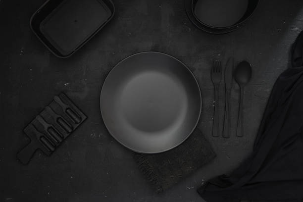 istock Empty black plate on grey stone table. Food background for menu. Flatlay, top view. 1444534219