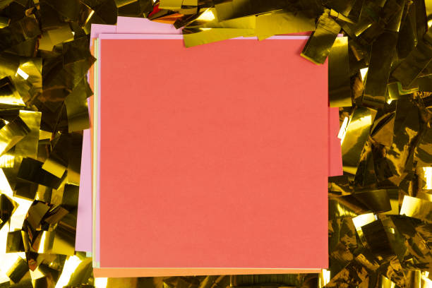 istock Red square sheet of paper on yellow sparkles, space for text, top view. 1444534289