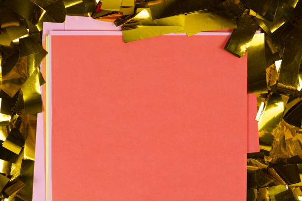 istock Red square sheet of paper on yellow sparkles, space for text, top view. 1444534306