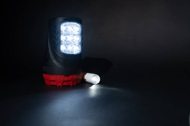 istock Two flashlights shine on a black background place for text 1444534334